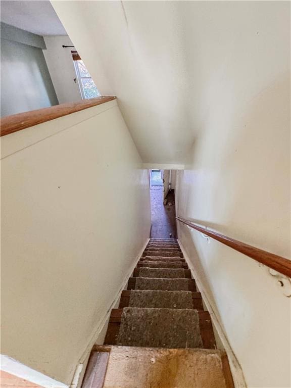 staircase with vaulted ceiling