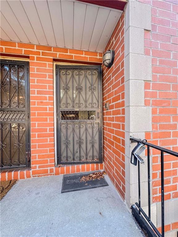 view of exterior entry with brick siding