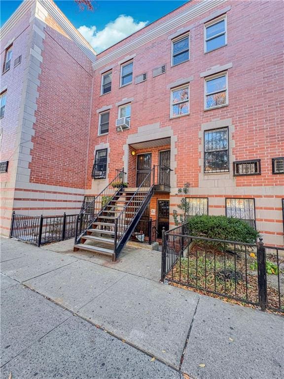 view of property with stairs and a fenced front yard