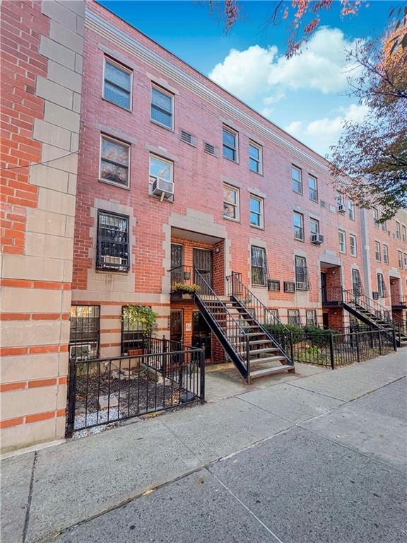 view of property with stairs and a fenced front yard