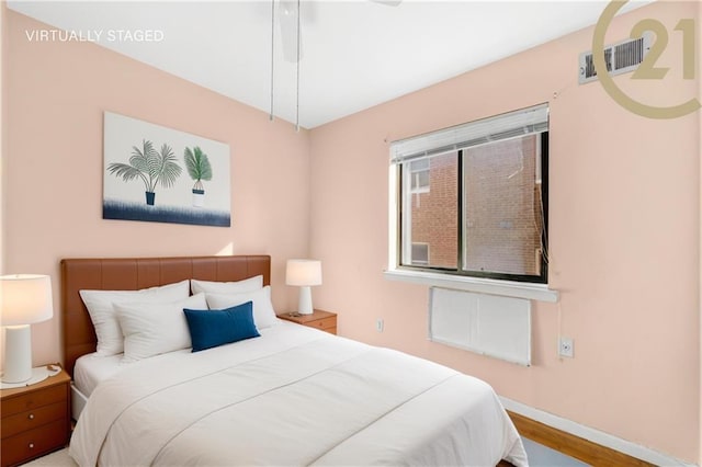 bedroom with ceiling fan and hardwood / wood-style flooring