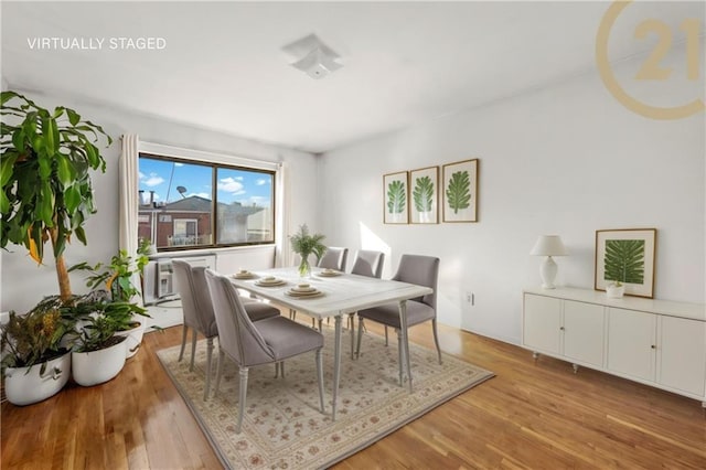 dining space with light hardwood / wood-style floors