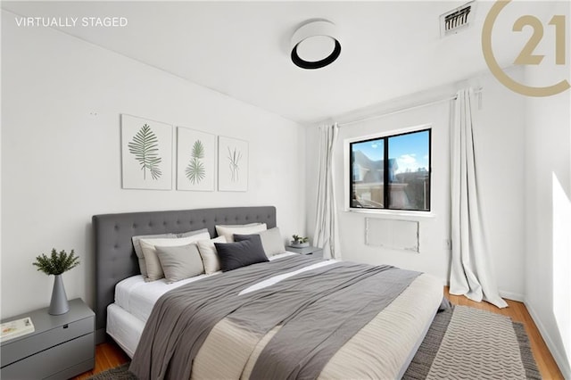 bedroom with dark hardwood / wood-style flooring