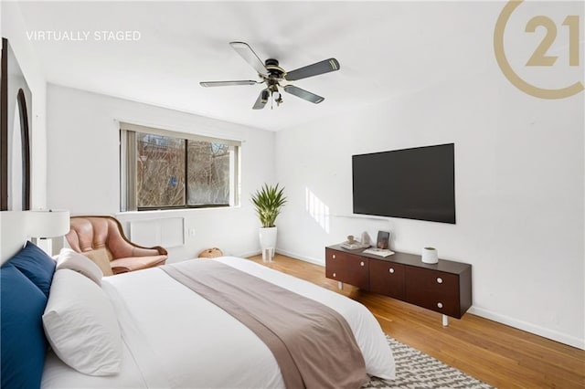 bedroom featuring ceiling fan and light hardwood / wood-style flooring