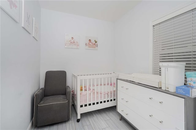 bedroom featuring a nursery area