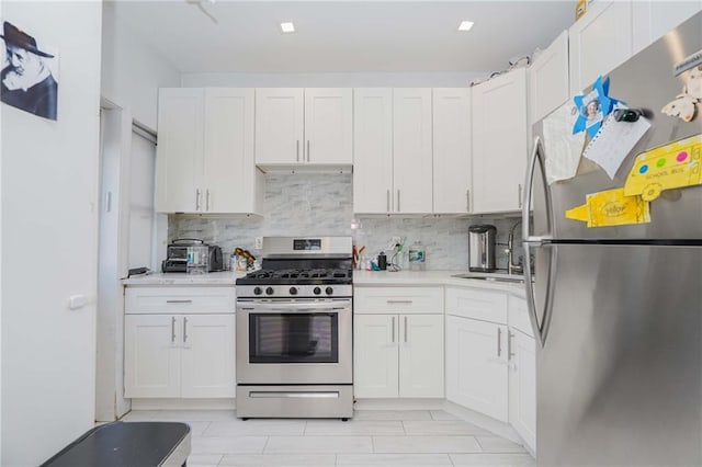 kitchen with white cabinetry, appliances with stainless steel finishes, and a sink