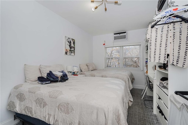 bedroom featuring a wall mounted air conditioner and baseboards