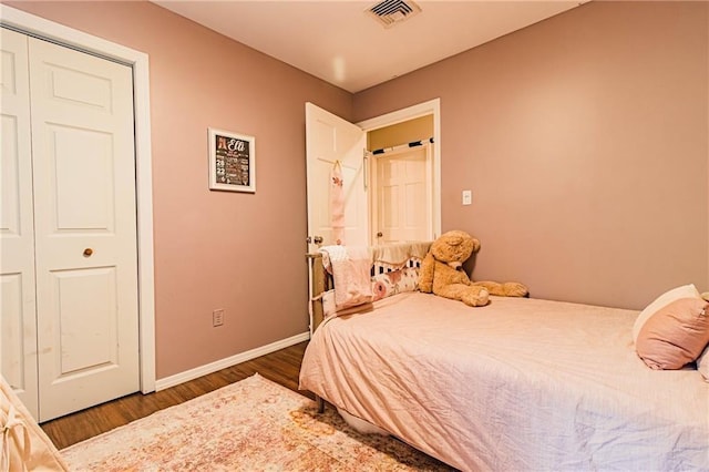 bedroom featuring a closet and dark hardwood / wood-style floors