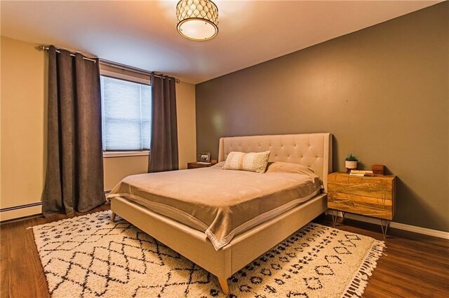 2572 W 16th St, Brooklyn, NY 11214 - bedroom with wood finished floors, baseboards, and a baseboard heating unit