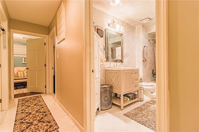 bathroom with tile patterned flooring, vanity, and toilet