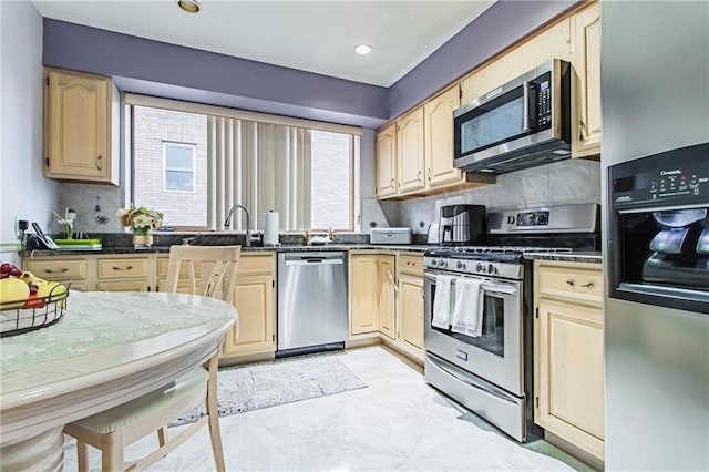 2572 W 16th St, Brooklyn, NY 11214 - kitchen featuring appliances with stainless steel finishes, light brown cabinetry, decorative backsplash, and recessed lighting