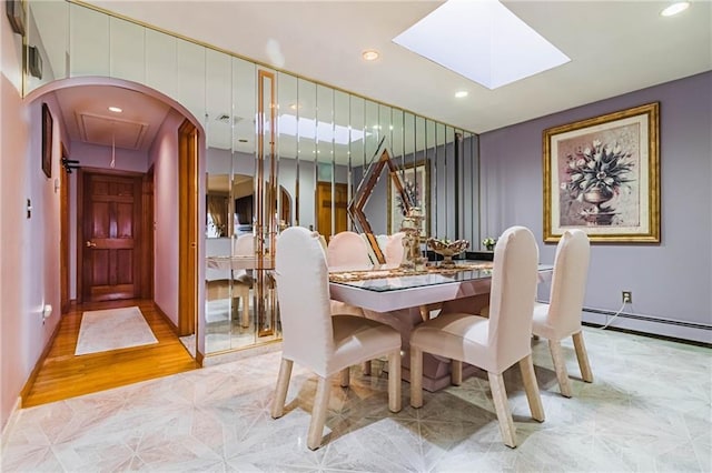 dining space featuring light wood-type flooring and baseboard heating