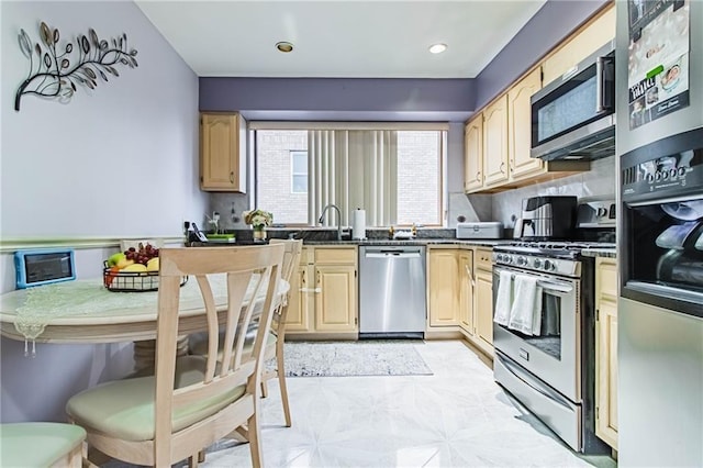 kitchen with decorative backsplash, appliances with stainless steel finishes, and light brown cabinetry