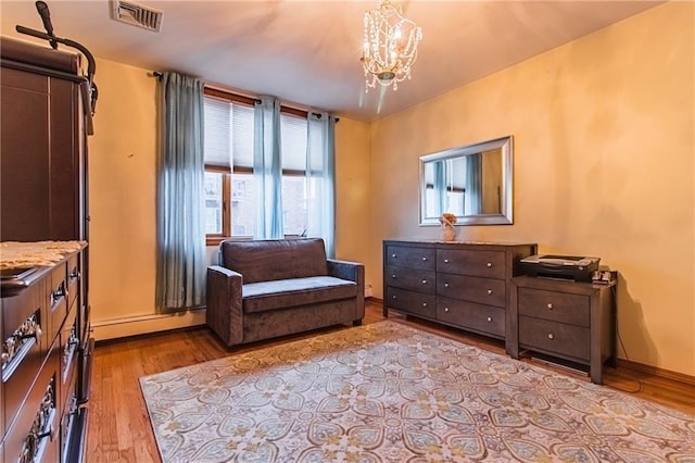 2572 W 16th St, Brooklyn, NY 11214 - sitting room with wood finished floors, a chandelier, and baseboard heating