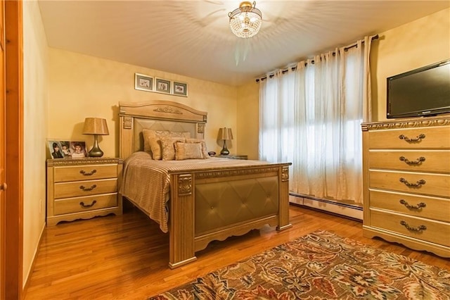 2572 W 16th St, Brooklyn, NY 11214 - bedroom with a baseboard radiator, a chandelier, and wood finished floors