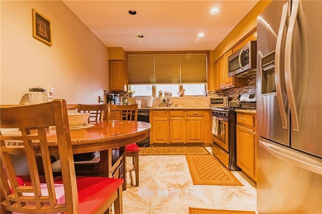 2572 W 16th St, Brooklyn, NY 11214 - kitchen featuring appliances with stainless steel finishes, light stone countertops, decorative backsplash, a sink, and recessed lighting