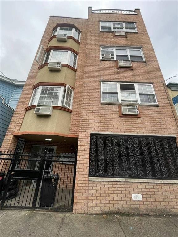 43-12 104th St, Corona, NY 11368 - view of building exterior with a fenced front yard