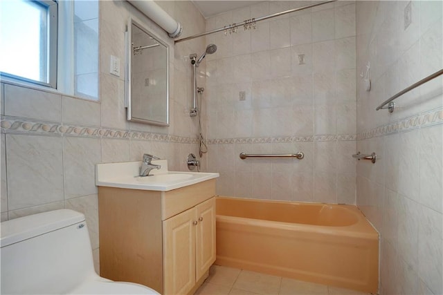 full bath with tile patterned floors, toilet, tile walls, and shower / bathing tub combination