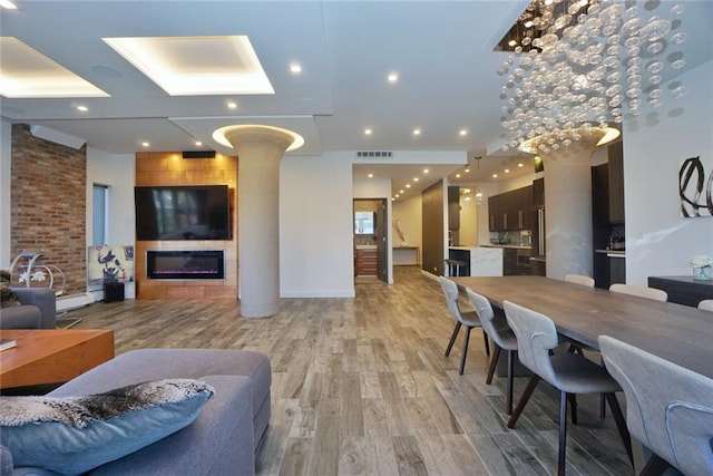 80 Bay St Unit 4A, Staten Island, NY 10301 - living area featuring a large fireplace, ornate columns, and light wood finished floors