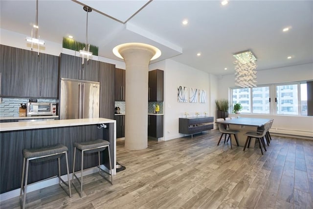 80 Bay St Unit 4A, Staten Island, NY 10301 - kitchen featuring high quality fridge, light countertops, modern cabinets, decorative backsplash, and light wood-style flooring