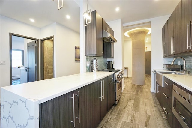 80 Bay St Unit 4A, Staten Island, NY 10301 - kitchen with stainless steel appliances, ornate columns, under cabinet range hood, modern cabinets, and light wood-type flooring