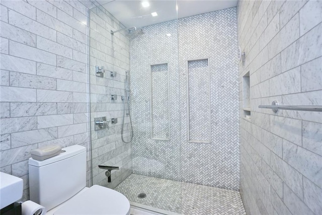 80 Bay St Unit 4A, Staten Island, NY 10301 - bathroom featuring tiled shower, toilet, and tile walls