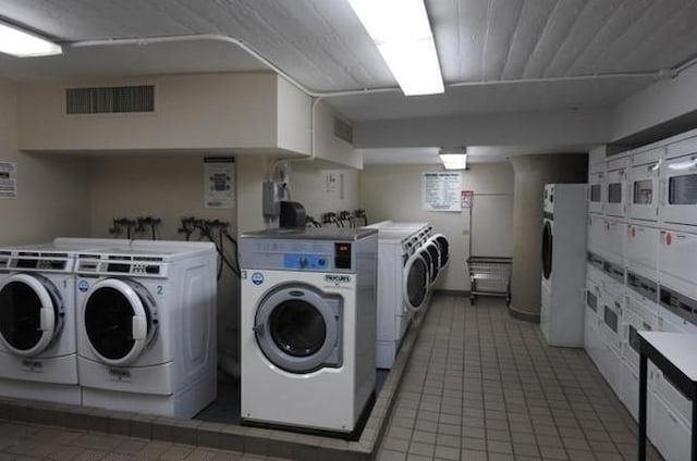 80 Bay St Unit 4A, Staten Island, NY 10301 - shared laundry with washing machine and dryer, stacked washer / dryer, and light tile patterned floors