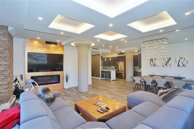 80 Bay St Unit 4A, Staten Island, NY 10301 - living room featuring ornate columns, light wood finished floors, a large fireplace, and recessed lighting