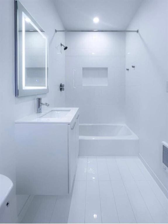 full bathroom with tile patterned flooring, vanity, toilet, and tiled shower / bath