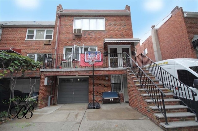 rear view of property featuring a garage