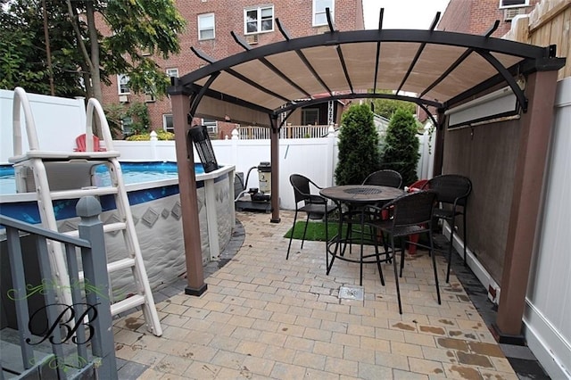 view of patio with a pergola and a fenced in pool