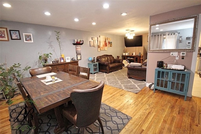 dining room featuring hardwood / wood-style flooring and an inviting chandelier