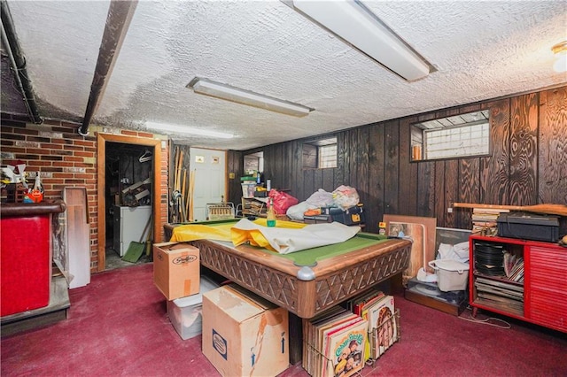 playroom featuring wooden walls, dark colored carpet, a textured ceiling, and billiards