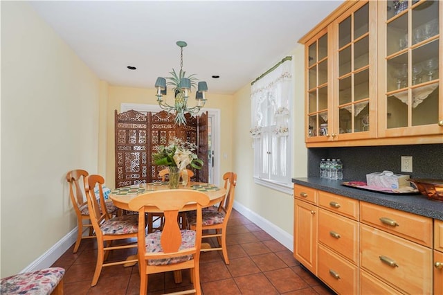 tiled dining area with a chandelier