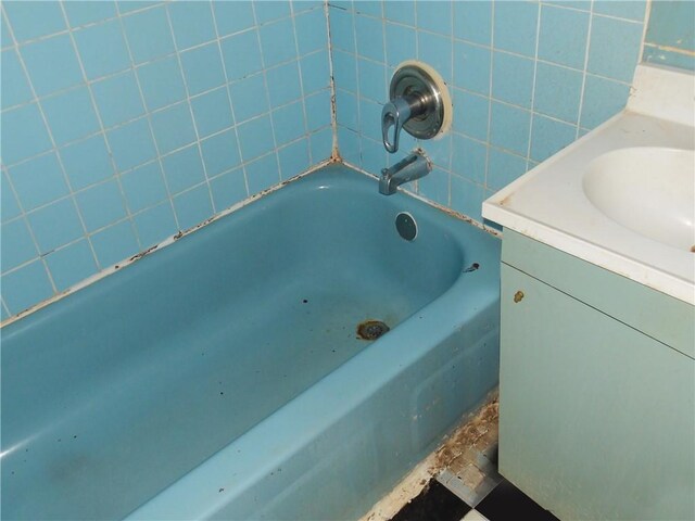 bathroom featuring a tub to relax in and vanity