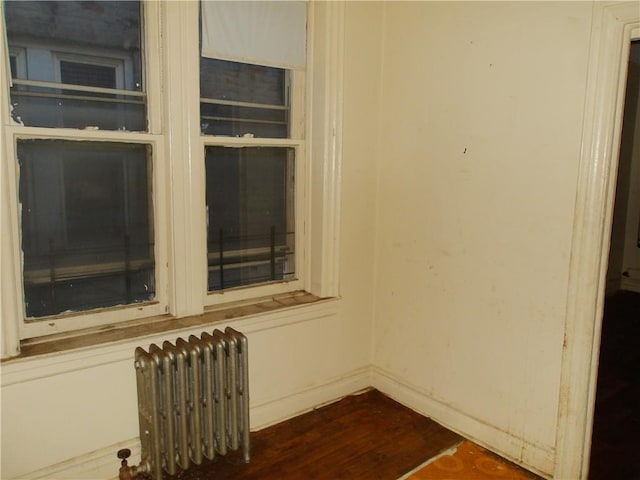 interior details featuring hardwood / wood-style floors and radiator heating unit