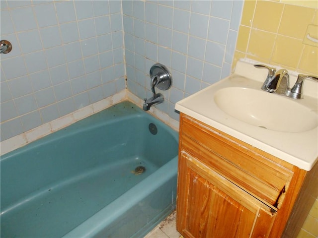 bathroom featuring vanity and a tub