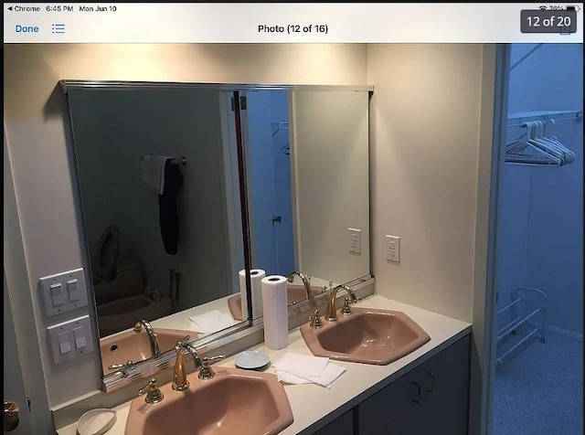 full bath with double vanity and a sink