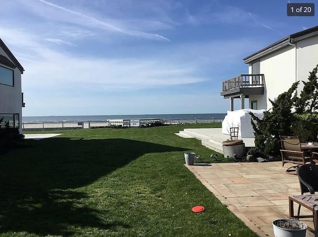 view of yard featuring a patio and a water view