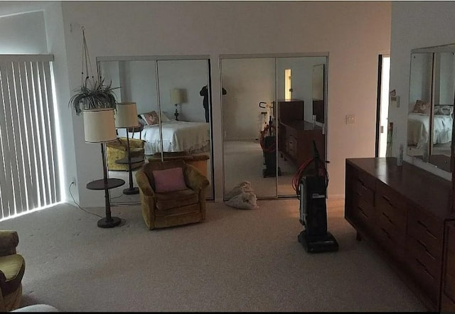 bedroom featuring carpet floors and two closets