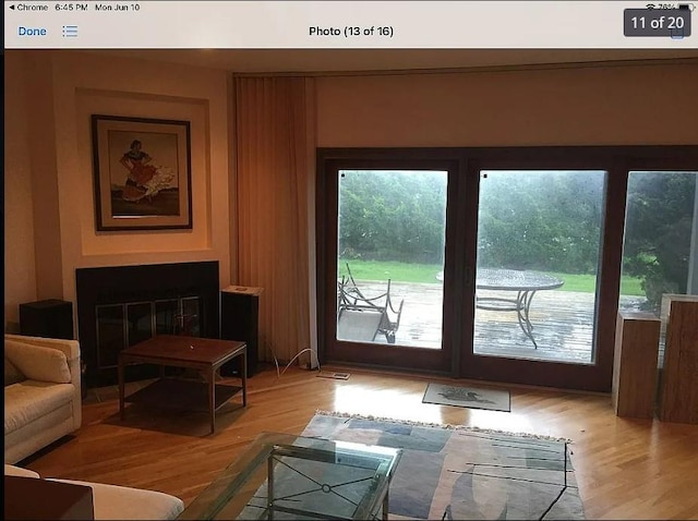 entryway featuring light wood-style flooring and a glass covered fireplace