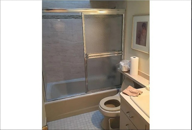 full bathroom featuring toilet, vanity, and bath / shower combo with glass door