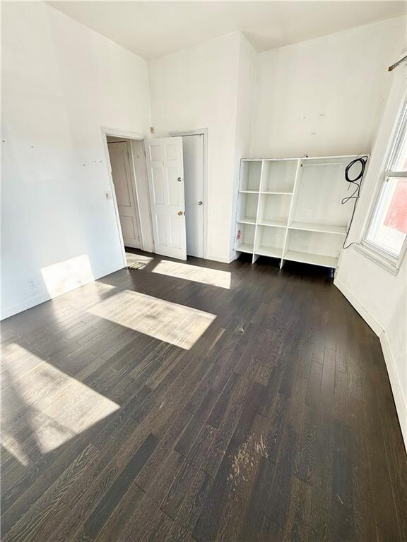 spare room with dark hardwood / wood-style floors