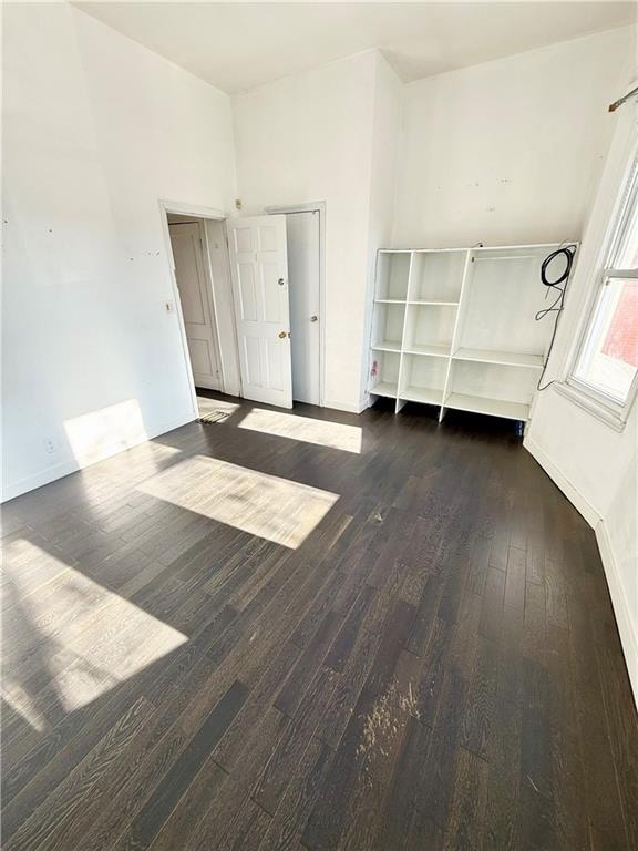 empty room featuring wood finished floors and baseboards
