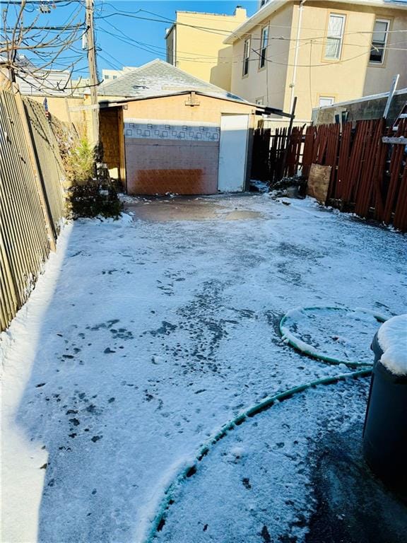 yard layered in snow featuring fence
