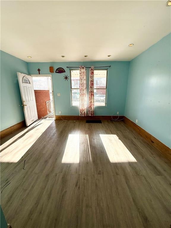 unfurnished room with wood finished floors and baseboards