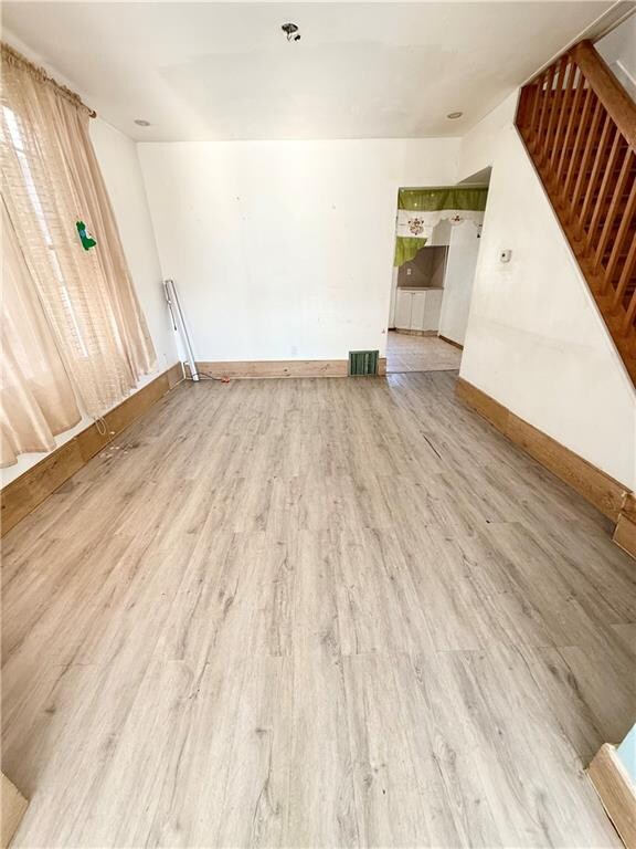 empty room with hardwood / wood-style flooring