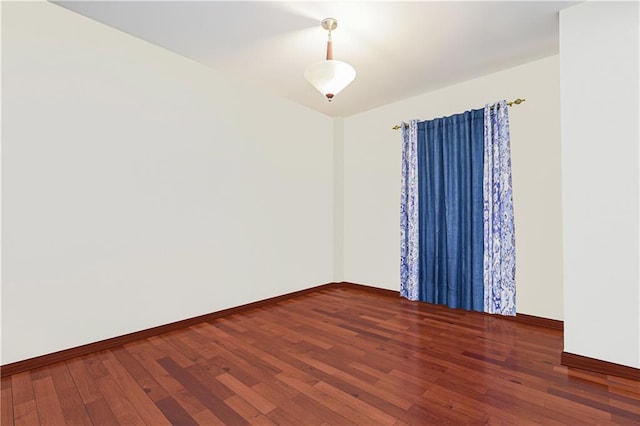 unfurnished room featuring dark wood-type flooring