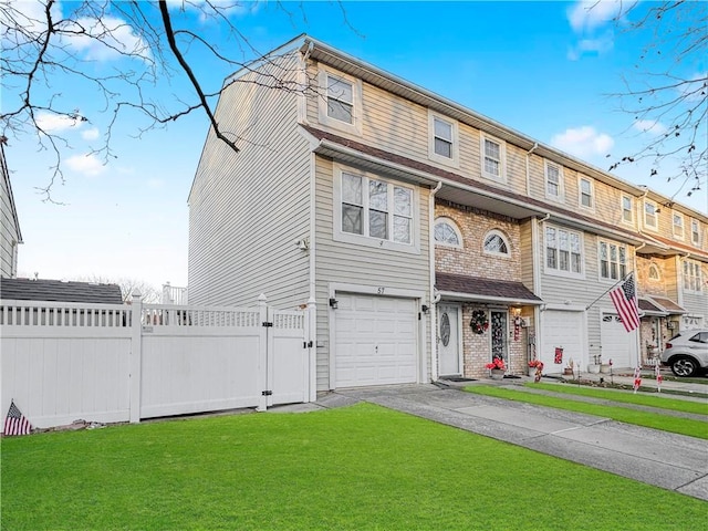 multi unit property with a garage and a front yard