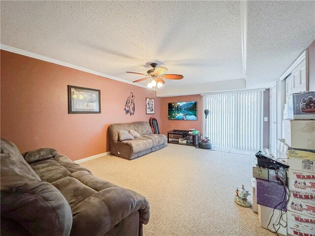 carpeted living room featuring a textured ceiling, ceiling fan, and crown molding